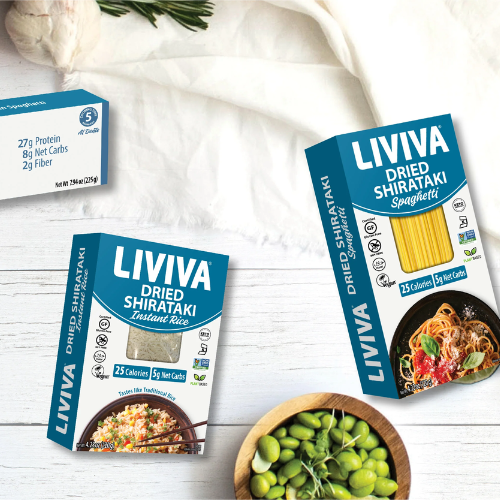 Boxes of Liviva dried Shirataki products on a white wooden surface with ingredients.