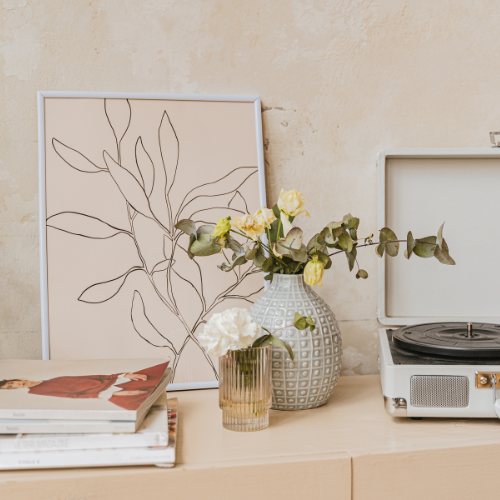 Minimalist home decor with modern art print, fresh flowers, and vintage record player