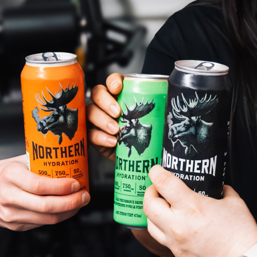 Three hands holding Northern Hydration energy drinks in orange, green, and black cans featuring bold moose logo