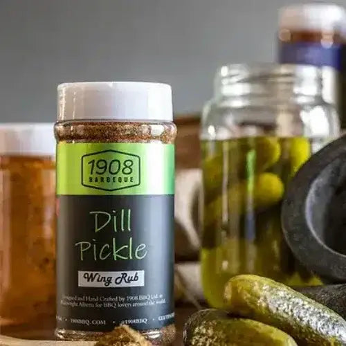 1908 Barbeque Dill Pickle Wing Rub bottle with pickles and a jar in the background