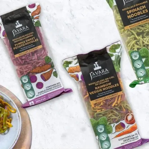 Packages of Javara noodles with colourful labels on a white textured background.