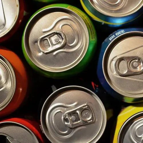Close-up of various colorful soda can tops.