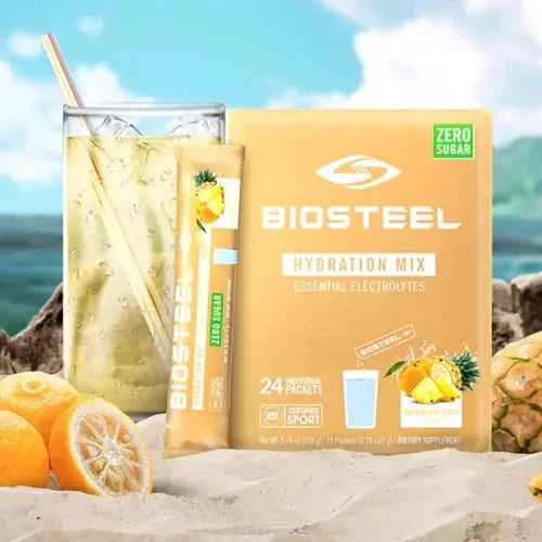 Biosteel hydration mix package with a glass of lemonade and pineapple.