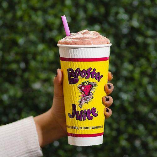 Booster Juice smoothie cup held in hand – Canadian-owned smoothie and juice bar brand
