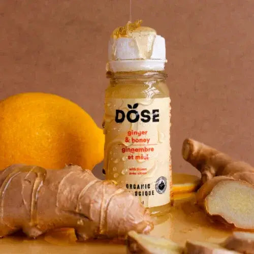 Dose ginger and honey drink with ginger root and lemon on a brown background