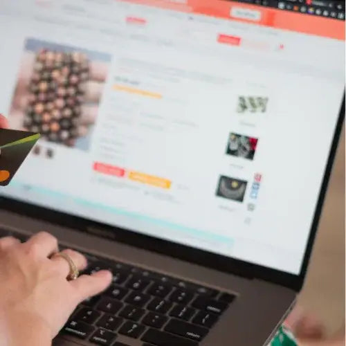 Person using a laptop with a shopping website displayed on the screen