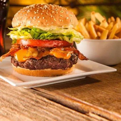 Cheeseburger with bacon, lettuce, and tomato served with fries from Canadian-owned Fatburger restaurant