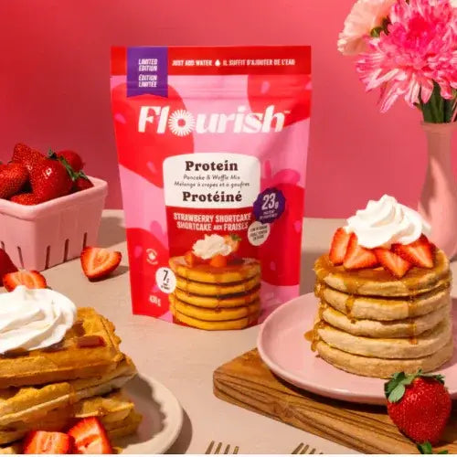 Flourish protein packaging with strawberry shortcake pancakes and waffles on a pink background