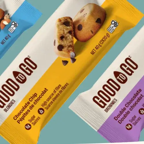 Packaged blondies and brownies with colourful packaging on a gradient background