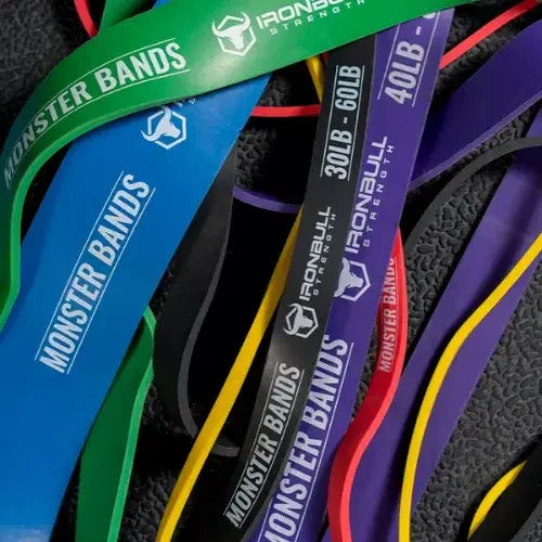 Colorful resistance bands with visible branding on a textured surface
