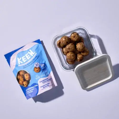 KEEN dog treats packaging with a container of treats on a light gray background