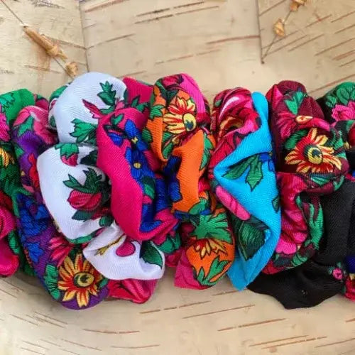 Colourful hair scrunchies on a wooden surface