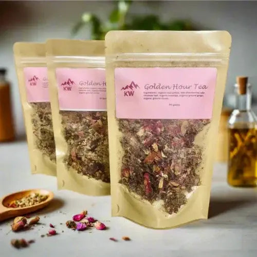 Three packages of Golden Hour Tea with a pink label on a light surface.