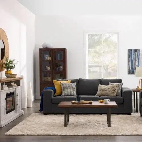 Living room with a gray sofa, wooden coffee table, and decorative pillows.