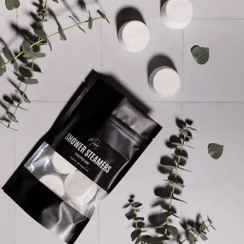Pack of shower steamers with eucalyptus leaves on a light gray background