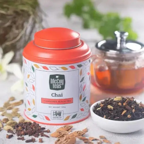 McCoy Teas Chai tea canister with tea leaves and a teacup in the background