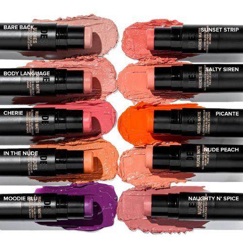 Nudestix multi-use makeup sticks in a variety of shades including Bare Back, Sunset Strip, Body Language, Salty Siren, Cherie, Picante, In The Nude, Nude Peach, Moodie Blu, and Naughty N’ Spice, displayed with swatches of creamy colour behind each stick.
