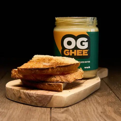 Jar of OG Ghee with toast on a wooden board