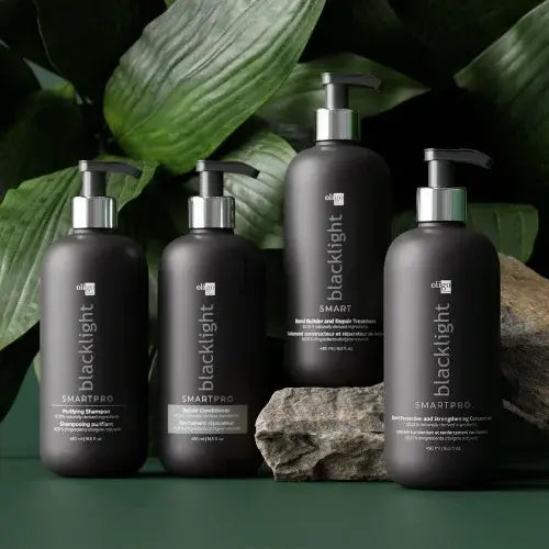 Black bottles of oligo hair products arrange on a green counter to show simplicity and sleekness
