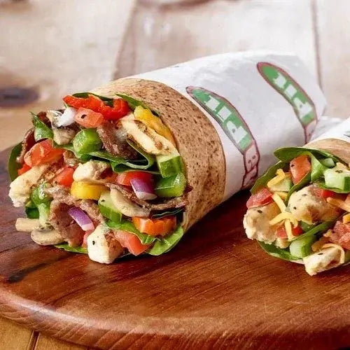 Colourful Pita Pit wrap with vegetables on a wooden board