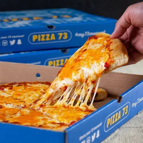 Hot and cheesy Pizza 73 slice being pulled from a box – Canadian pizza chain serving classic comfort food.