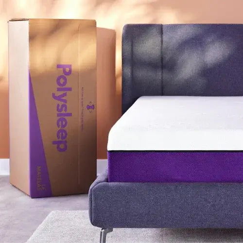 Polysleep mattress partially unboxed on a modern upholstered bed with branded packaging nearby
