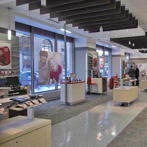 Interior of a Rogers retail store featuring cell phones, accessories, and promotional displays, with modern design elements and large street-facing windows letting in natural light