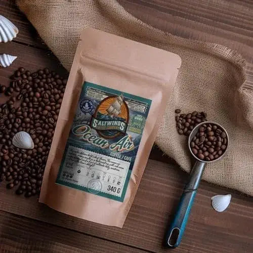 Coffee bag labeled 'Ocean Air' with coffee beans and a scoop on a wooden surface