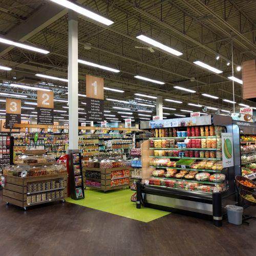 Interior of Save-On-Foods grocery store featuring fresh produce, healthy snacks, and clearly marked aisles with wooden signage and bright lighting