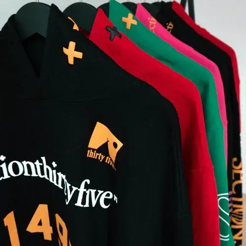 Row of hoodies with 'thirty five' logo and text on a white background