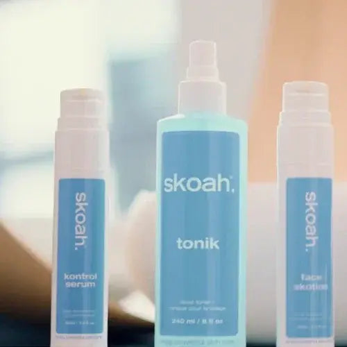 Three Skoah skincare products with blue and white packaging.