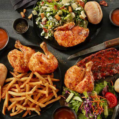Swiss Chalet rotisserie chicken meals with ribs, fries, salads, and dipping sauce – classic Canadian family restaurant