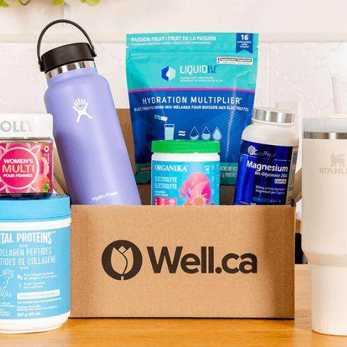Well.ca box filled with wellness products, supplements, and reusable water bottles on a kitchen counter