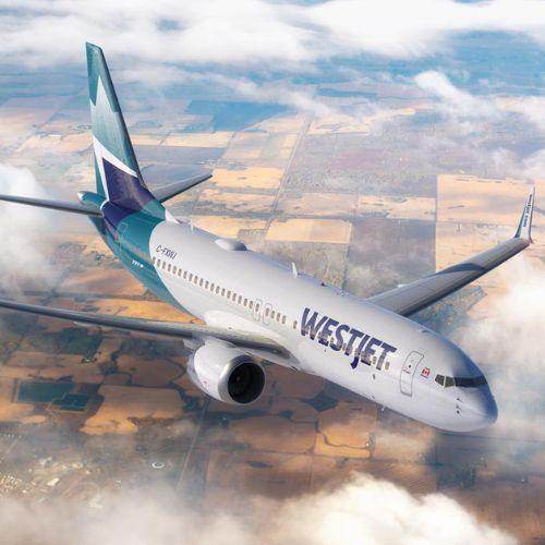 WestJet airplane flying above the clouds over patchwork farmland