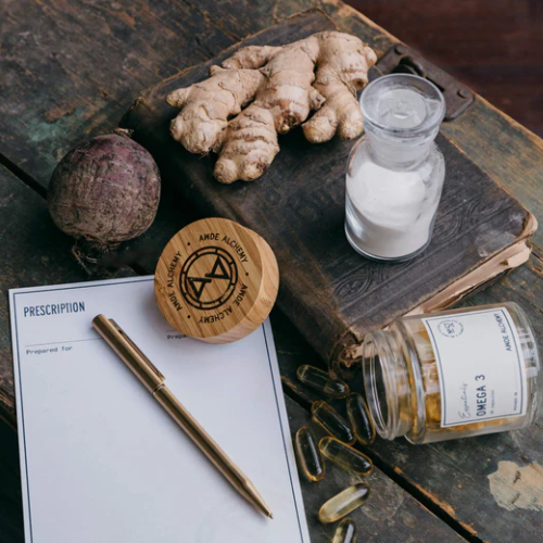 Herbal ingredients and a prescription pad on a wooden surface