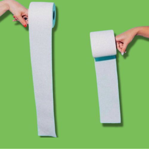 Two rolls of white paper with blue edges held by hands on a green background