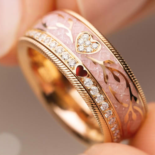 Close-up of a gold ring with pink gemstone and diamond accents.