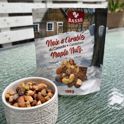 Bag of Basse maple nuts with a bowl of nuts on a glass table