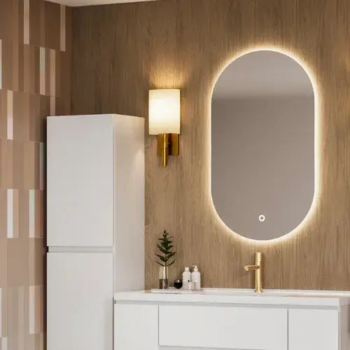 Bathroom with a illuminated mirror, sink, and wall lamp.