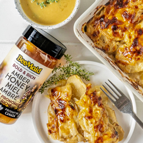 Baked dish with a jar of BeeMaid honey on a plate
