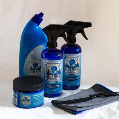 Blue Moon cleaning products including a bottle, spray bottles, and a jar on a white background