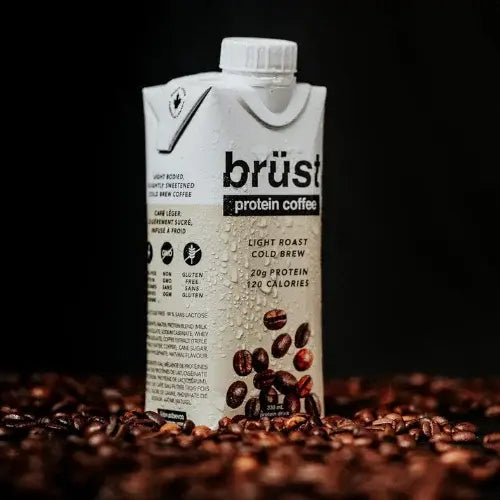 Brust protein coffee carton on a bed of coffee beans with a dark background