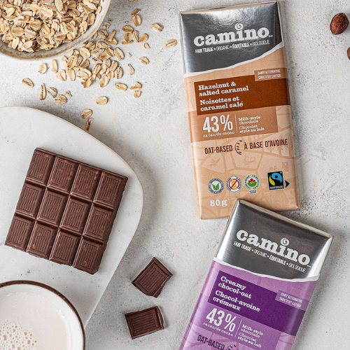 Camino chocolate bars with packaging on a light surface with oats.