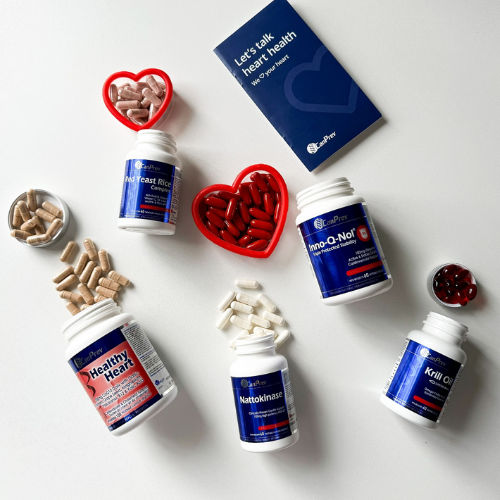Supplement bottles and containers on a white surface with a focus on heart health.