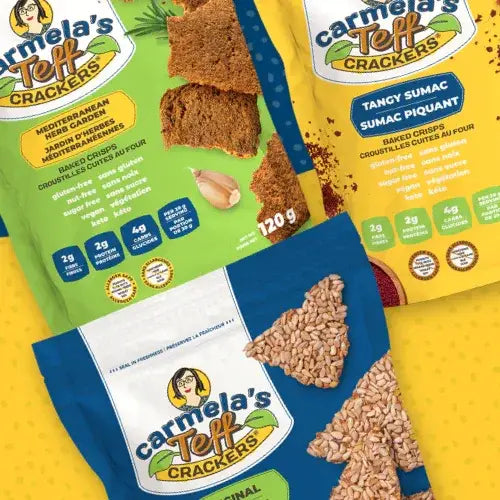 Three packages of Carmela's Teff Crackers on a yellow background