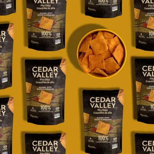 Cedar Valley pita chips packaging and a bowl of chips on a yellow background