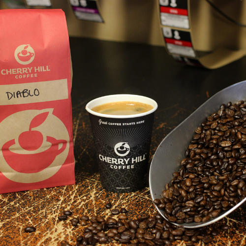 Cherry Hill Coffee packaging, cup, and coffee beans on a counter