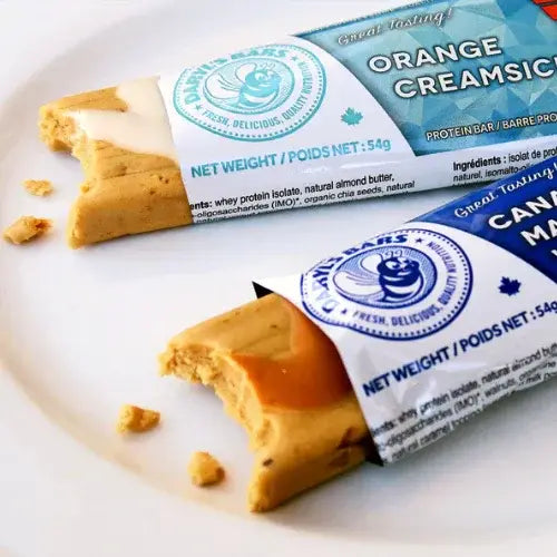 Two protein bars with visible branding on a white surface