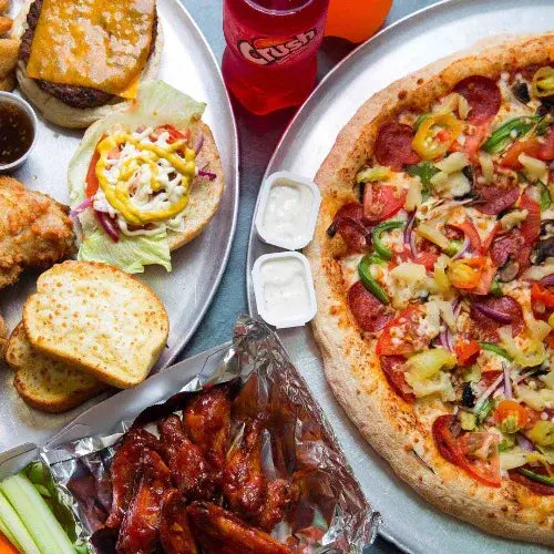 Assorted food items including a pizza, burgers, and fries on a platter.