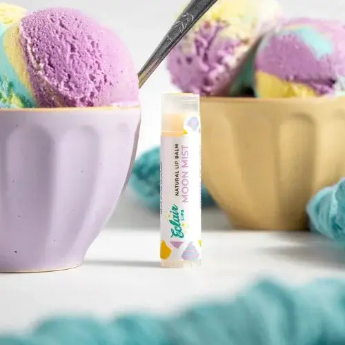Lip balm tube labeled 'Moon Mist' with ice cream in the background